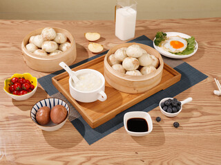 Delicious Traditional Chinese Dim Sum Breakfast with Xiao Long Bao Dumplings and Milk in Sunshine Light