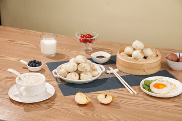 Chinese Breakfast Feast with Steamed Bao Dumplings and Congee Soup on Wooden Table