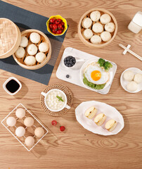 Traditional Chinese Dim Sum Xiao Long Bao Dumplings and Snacks on Wooden Table for Delicious Afternoon Meal