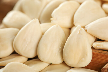 Peeled Almond Slices and Whole Almonds on Wooden Background - Natural Healthy Nuts