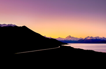 Car light trail on Mt Cook road under a stunning sunset