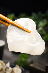 Changbaishan White Ear-Shaped Dumpling with Chopsticks - Traditional Northeastern Chinese Food Preparation