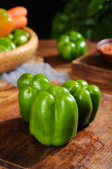 Fresh Green Bell Peppers on Wooden Cutting Board - Healthy Vegetable Cooking Ingredients
