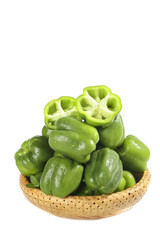 Fresh Green Bell Peppers and Sweet Peppers in Wicker Basket on White Background