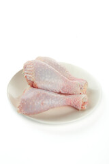Raw Chicken Legs on White Plate Isolated on White Background