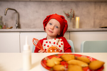 Young child enjoys baking cookies in a cozy kitchen during a festive holiday season