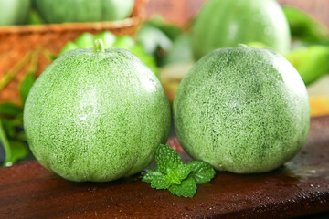 Fresh Green Shandong Melons with Mint on Wooden Table - Healthy Organic Fruit Display