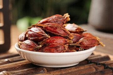 Dried Gardenia Buds Sichuan Herbal Spice in White Bowl Traditional Chinese Medicine Ingredient