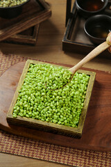 Fresh Green Wheat Kernels in Wooden Box with Spoon on Rustic Table Display