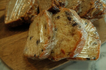 Saran plastic wrapped sliced blueberry muffin slices, bake sale pastry