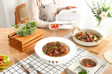 Rustic Farmhouse Kitchen with Hearty Meat Stew in Iron Pot and Ceramic Dishes