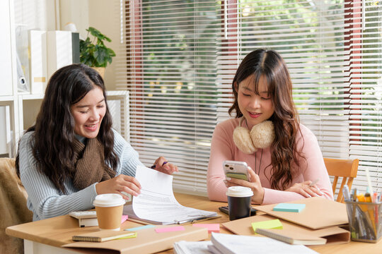 Young business people busy working in modern office, team members meet to consult financial documents, collaborate on project, fostering productive work environment for growth