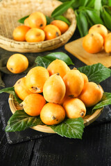Fresh Yunnan Mountain Loquats in Wicker Baskets - Sweet Tropical Fruit Display with Green Leaves