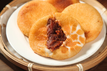 Asian Glutinous Rice Cake with Red Bean Paste Filling in Bamboo Steamer
