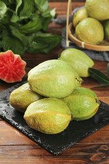 Fresh Guava Fruits on Slate Board - Tropical Fruit Display with Red Heart-Shaped Slice