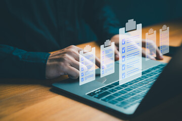 Digital checklist concept showing a person working on a laptop with task icons, representing...
