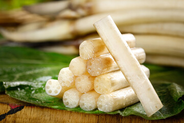 Fresh Lotus Root Vegetable Slices with Hollow Chambers on Green Leaves - Traditional Asian Cooking Ingredient