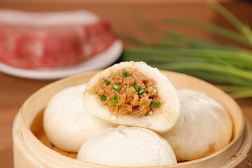 Steamed Pork Buns with Scallion and Fresh Meat Filling in Bamboo Steamer Traditional Chinese Dim Sum