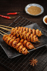 Roasted Spiral Sausage Skewers with Sesame Seeds and Spicy Dipping Sauce Ready to Eat