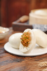 Handmade Pork and Scallion Steamed Buns Traditional Asian Dim Sum Dumplings on White Plate
