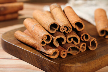 Natural Cinnamon Sticks from Guangxi China - Aromatic Spice Rolls on Wooden Board for Cooking and Seasoning