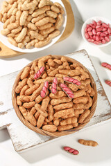 Fresh Raw Peanuts in Shells and Skinned Red Peanuts in Wooden Bowls on White Background