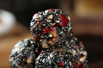 Handmade Energy Balls with Black Sesame Seeds and Dried Fruit - Nutritious Healthy Snack Food Closeup