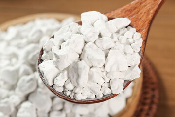 Raw potato starch flour in wooden spoon - natural cooking ingredient
