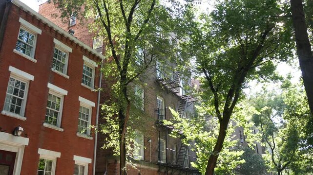 New York City urban residential buildings architecture, Manhattan classic street, Greenwich village, United States of America. Typical red brick house in NYC, real estate property in USA. West village