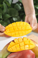 Fresh Cut Mango Cubes in Hands - Ripe Golden Tropical Fruit Ready to Eat