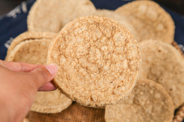Crispy Golden Tofu Snack - Hand Holding Vegetarian Protein Food with Textured Surface