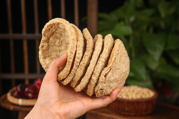 Sliced Dried Spiced Tofu in Hand - Traditional Asian Vegetarian Protein Food Ingredient