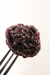 Dried hibiscus flower on fork - dehydrated edible petals for tea and cooking