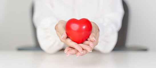 woman hand holding red heart shape. love, donor, September world heart day, world health day, CSR donation and Insurance concepts
