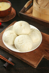 Traditional Chinese Steamed Buns with Bamboo Steamer and Chopsticks on Wooden Board