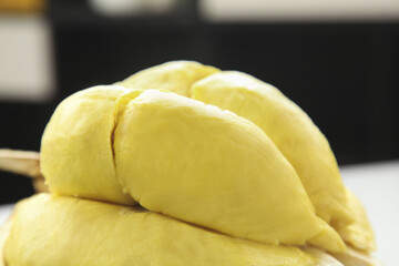 Fresh Golden Durian Fruit Segments - Exotic Tropical Asian Delicacy on Wooden Surface