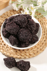 Dried Candied Plum Fruits in Bowl - Traditional Asian Preserved Snack with Flowers