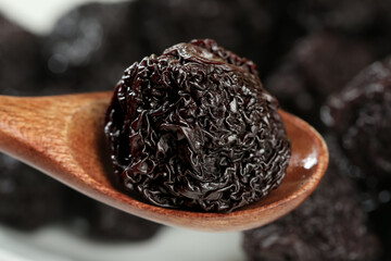 Dried Plum on Wooden Spoon - Traditional Candied Fruit Snack