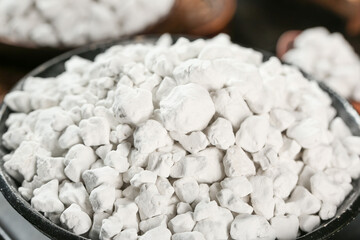 Raw potato pieces coated in flour for handmade cooking preparation in kitchen bowl