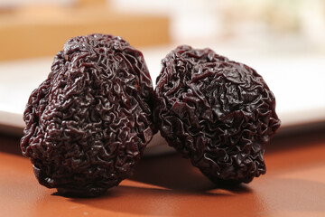 Dried Plums Prunes Healthy Snack Food Ingredients on Wood Background