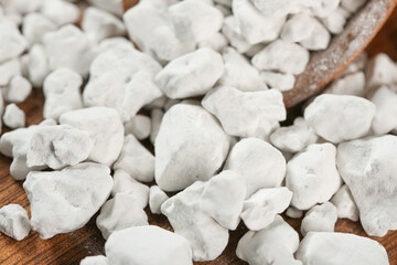 Raw Potato Starch Flour Granules on Wooden Spoon - White Powdery Cooking Ingredient