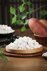 Raw Potato Starch Granules with Fresh Potatoes on Wooden Plate - Natural Food Ingredient