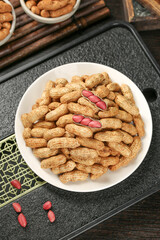 Fresh Raw Peanuts in Shell with Red Coated Nuts on Wooden Surface