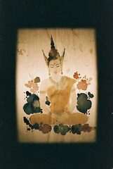 Vintage Buddha artwork with subtle ink-like stains
