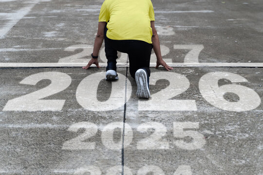 Runner at start line with overlapping year numbers symbolizing progress toward 2026 goals, vision and success