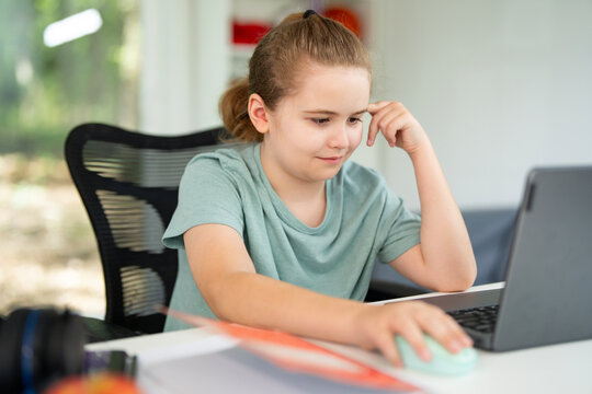 E-learning. Home learn for child. Kid learning on laptop e-learning. Teen student learn lesson on laptop. Child study schoolwork in home classroom interior. Online learn. Education and learning online - Powered by Adobe