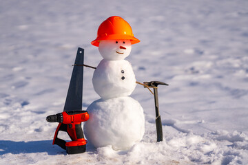 Snowman in a snowy winter field. Funny snow man with scarf and hat. Snowman for Christmas card. Winter snowman in frozen landscape. Snow man wearing gloves and hat. Snowman in wintertime.