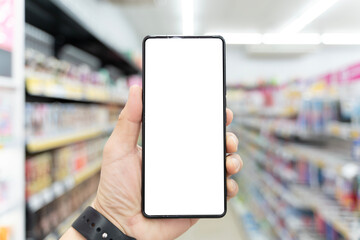 Blank smartphone screen held in supermarket for shopping app mockup, retail technology and digital marketing