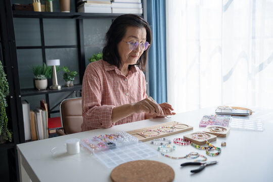 Senior mature older asian woman Art hobby handmade making beads jewellery accessories handcraft hobby
