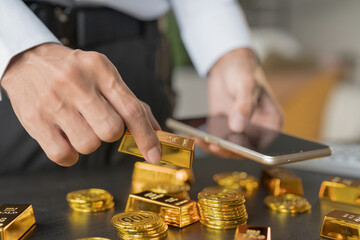 Gold Trading business man hand offering gold Investment in gold mining company or Trading gold on the stock exchange Rising gold prices.